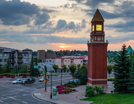 Clock tower and sunset in urban landscape.